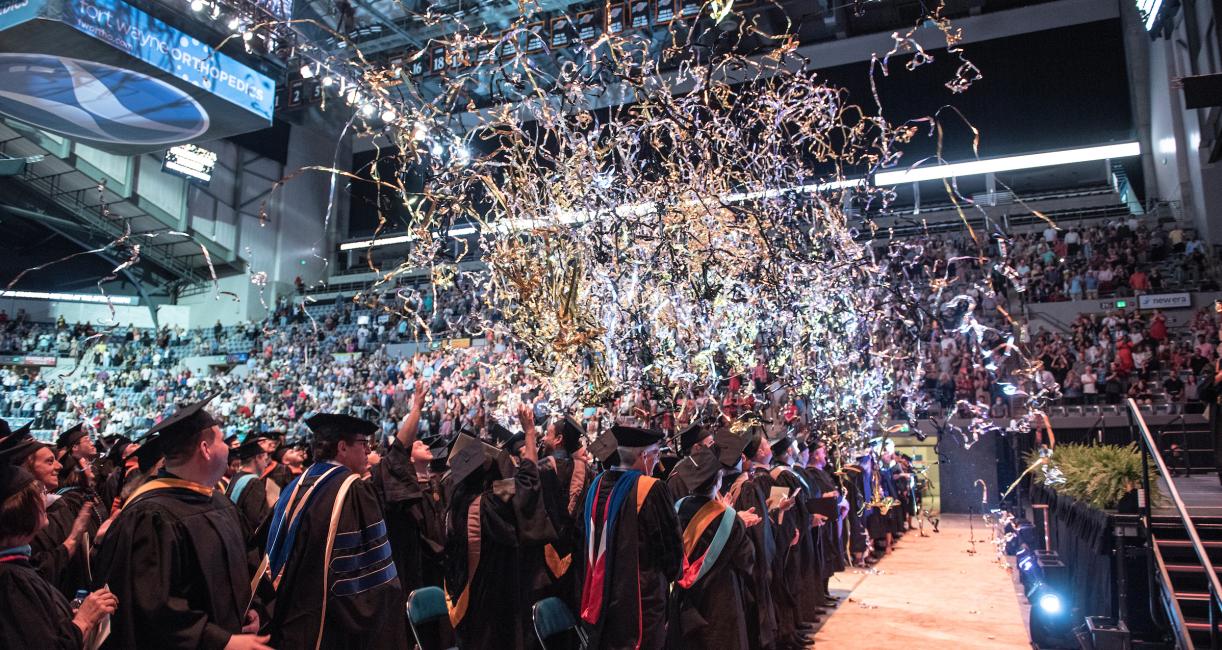 Streamers and confetti over the graduation crowd.