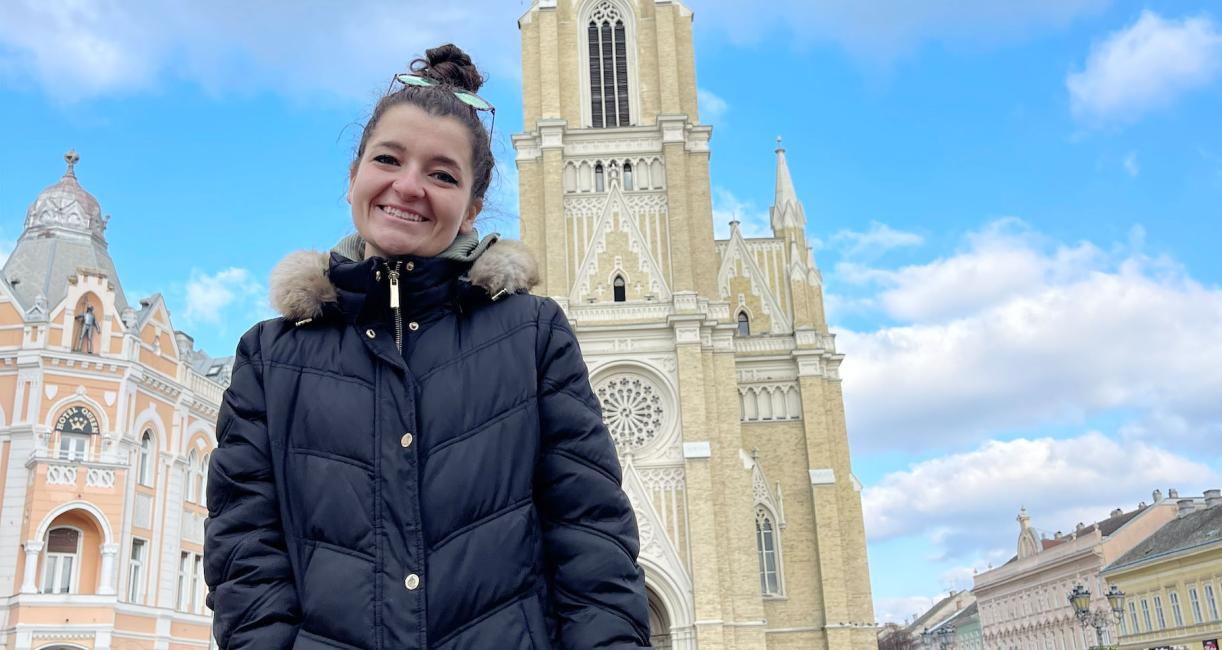 Maddie Book is standing in front of a cathedral