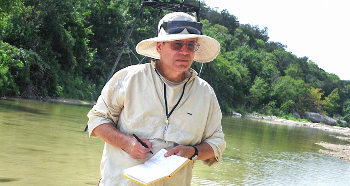 James Farlow is in the Paluxy River researching dinosaurs