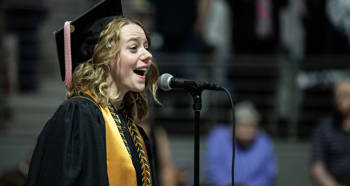 Student sings the National Anthem.