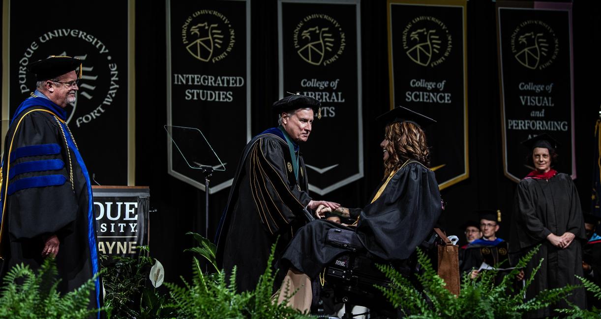 Student walking across the stage.