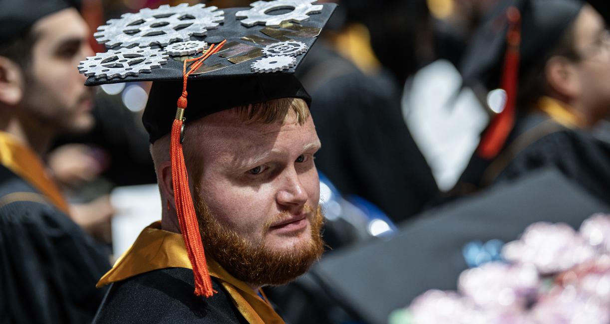 ETCS graduating student with gears decorating the cap.