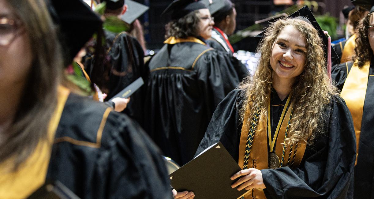 Graduating students smiling after the ceremony.