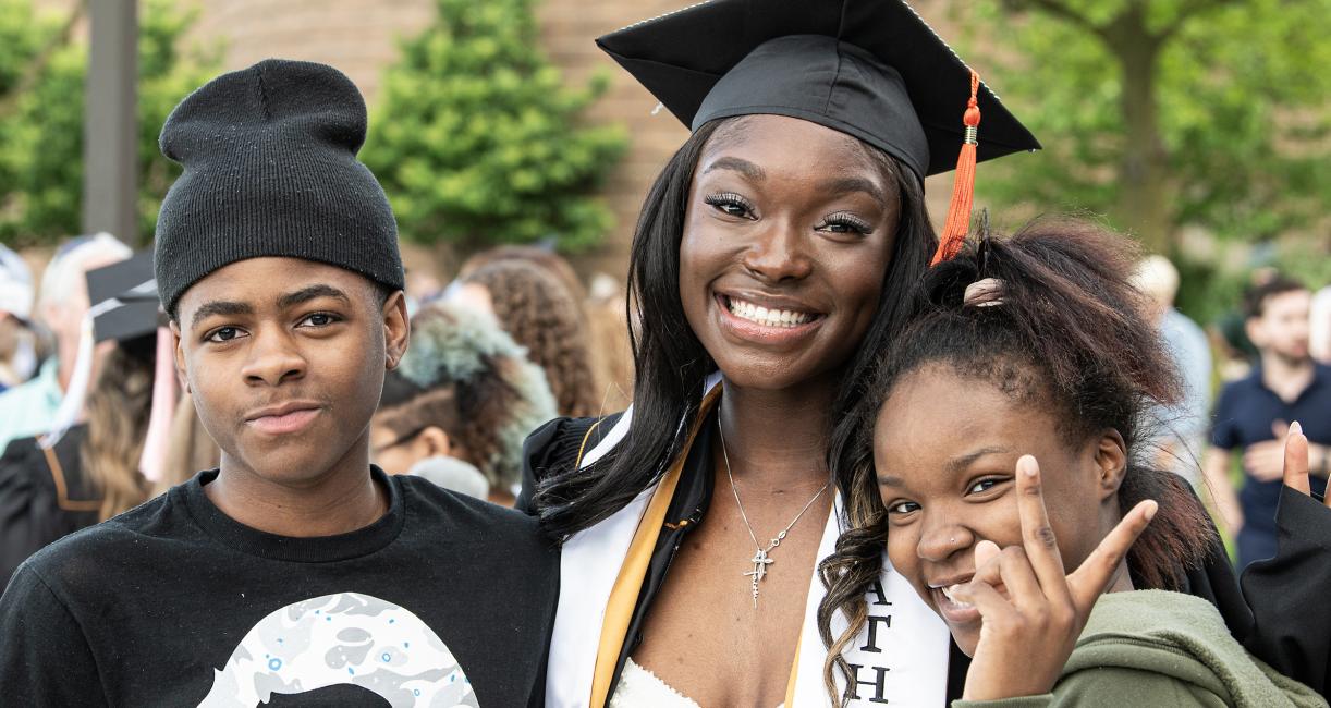 Graduated student poses with family.