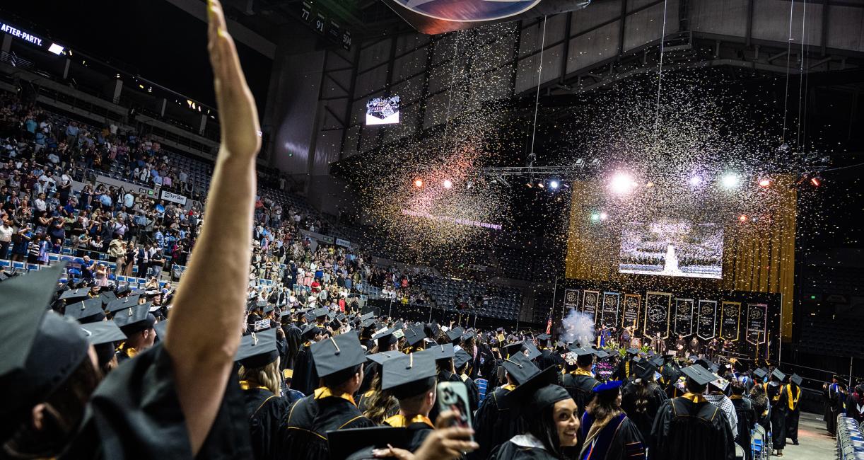 Students cheer as the confetti is released.