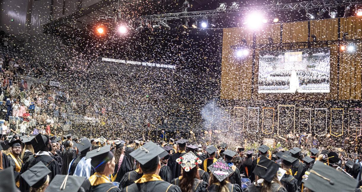 Students cheer as the confetti is released.