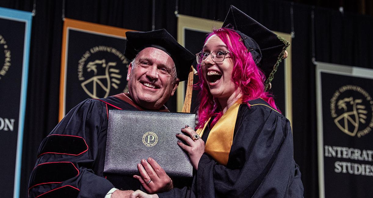 A student is awarded her diploma by the VPA dean