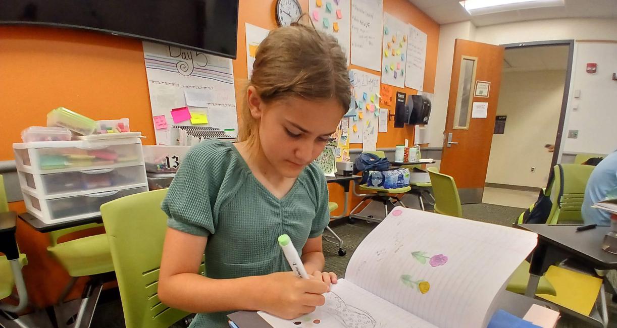 Chloe Hoffman, 11, a sixth grader at Maple Creek Middle School, works on a drawing as part of the Appleseed Writing Project summer camp at PFW.