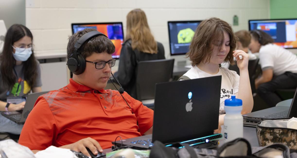 Students are working on computers at VR camp