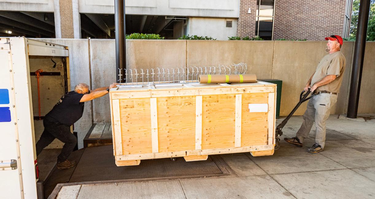 Mike Thom of Trenton, Ontario’s Research Casting International, right, and Garth Dallman, begin unloading the mastodon bones on Monday morning, Aug. 12.