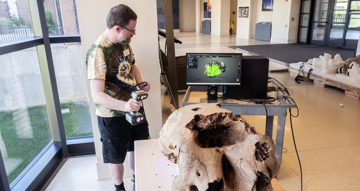 Graham Fredrick, library systems specialist, was part of a team including Erika Mann, director of library technology and digital initiatives, and Daniel Lin, information services technician, who scanned the baby mastodon’s skull for 3D digitization.