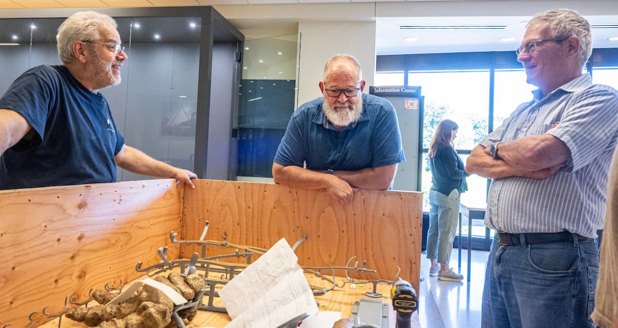 From left to right, Research Casting International’s Mike Thom, Ben Dattilo, professor of geology, and James Farlow, adjunct professor, examine some of the bones during a break.