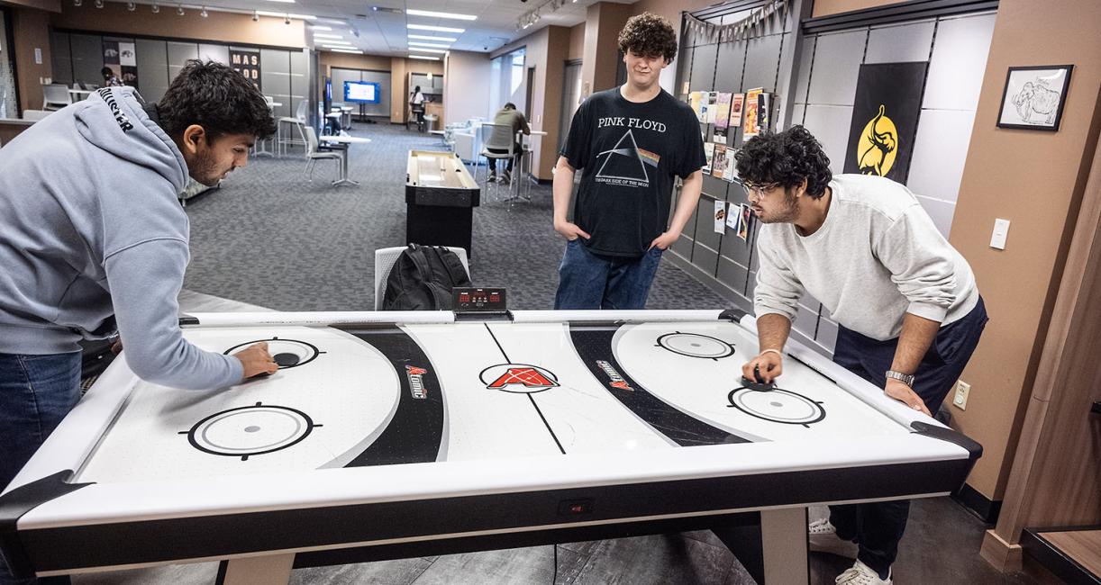 Students are playing air hockey