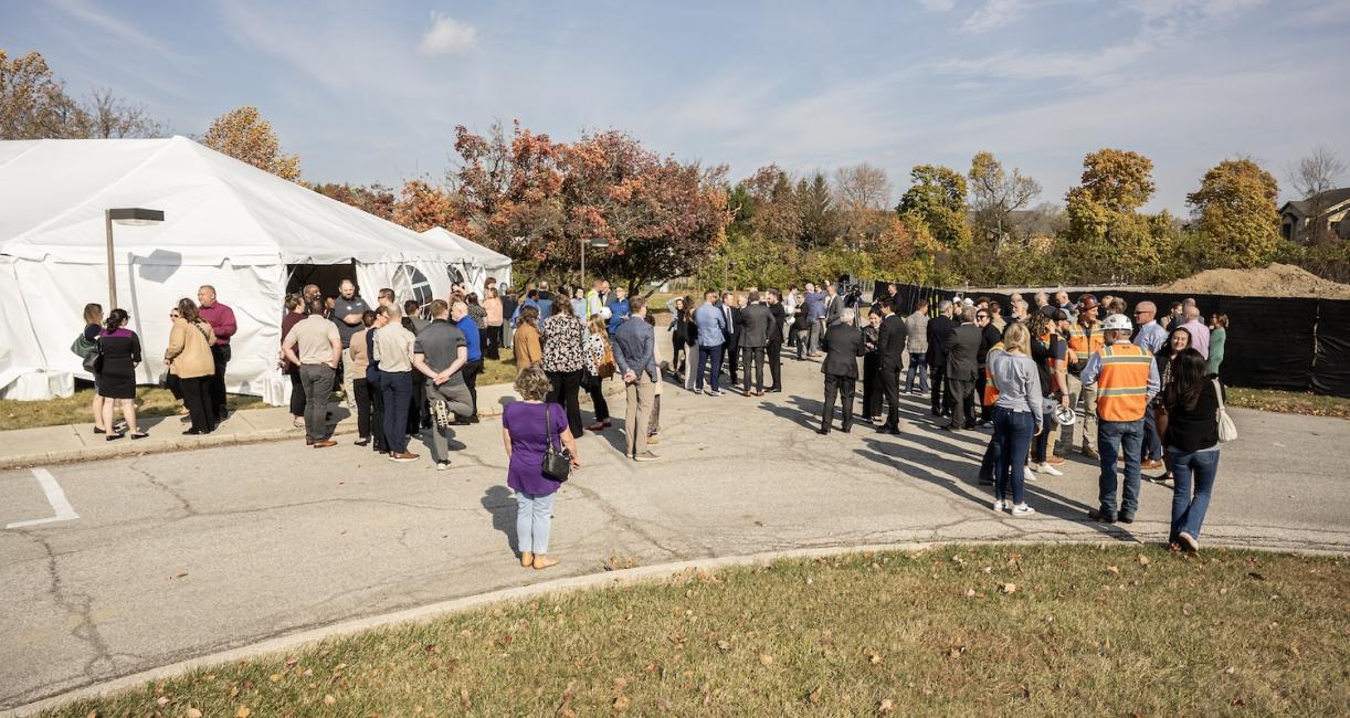 Trace groundbreaking crowd.