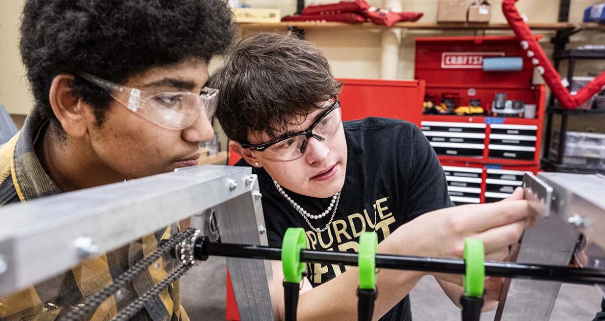 Drew Clem is working with robotics team students