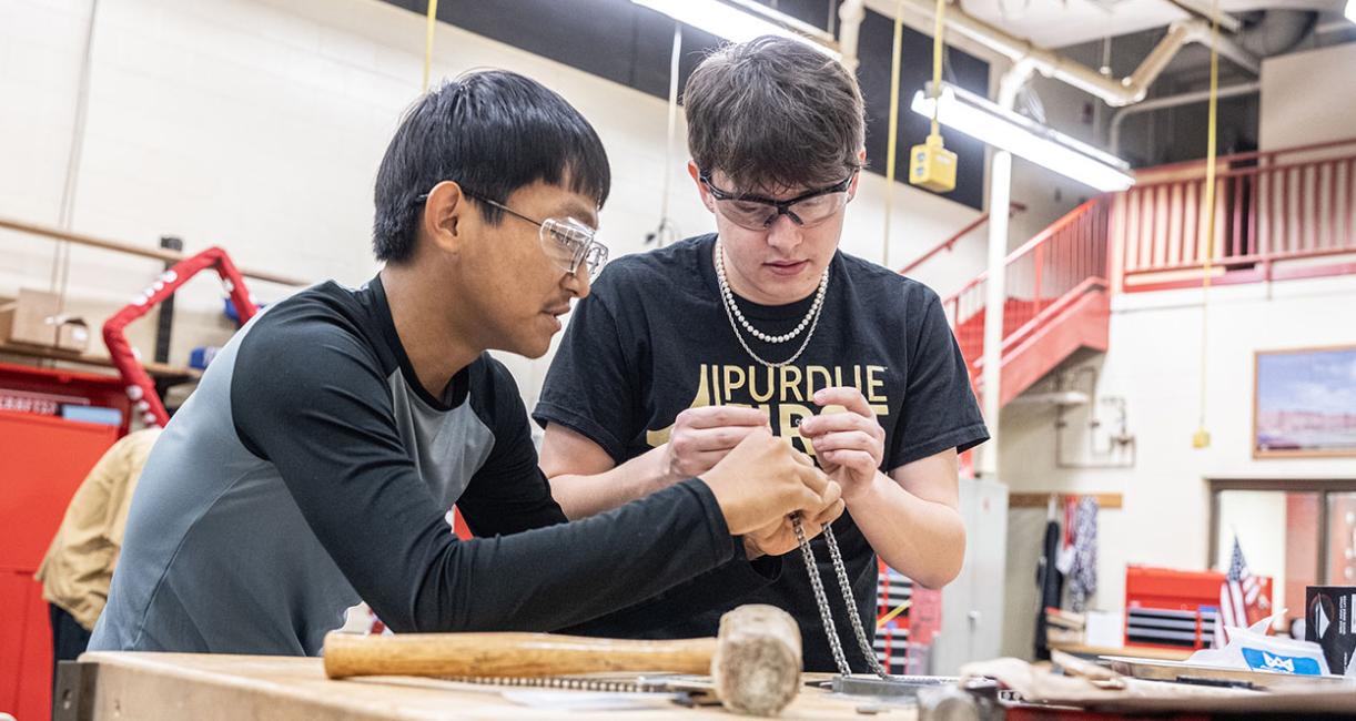 Drew Clem is working with robotics team students